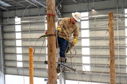 Apprentice Lineman Robert Sheely demonstrates how CenterPoint Energy trainees learn to build new electric line construction on wooden utility poles at the Hiram O. Clarke Training Center. Apprentice Lineman Robert Sheely demonstrates how CenterPoint Energy trainees learn to build new electric line construction on wooden utility poles at the Hiram O. Clarke Training Center.