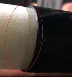 Damage to the insulation (off white groove), introduced during the outer semiconducting layer (black) cutback at a separable connector (T-body) termination with substandard performance (per IEEE 386) from the first case study. Damage to the insulation (off white groove), introduced during the outer semiconducting layer (black) cutback at a separable connector (T-body) termination with substandard performance (per IEEE 386) from the first case study.