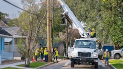 Crews replace a distribution pole in New Orleans in January 2023. Most of the U.S.&rsquo;s utility poles have been in use for 50 years to 60 years, which raises concerns about resiliency when considering the biological life expectancy of wood.