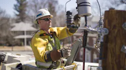A worker installs poletop gear to a distribution line. National Grid’s Future Grid Plan, backed by DOE funding, will invest in network infrastructure, new transformers, power lines and substations, including line monitoring systems and communications systems.