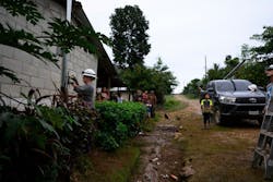 Oklahoma co-op volunteer, Stephanie Jones from Cimarron Electric Cooperative, installs a meter on a pole outside a home in a rural village. Oklahoma co-op volunteer, Stephanie Jones from Cimarron Electric Cooperative, installs a meter on a pole outside a home in a rural village.