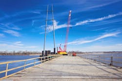 A temporary trestle provides a crane access to reinforce a transmission tower foundation in the Platte River. A temporary trestle provides a crane access to reinforce a transmission tower foundation in the Platte River.