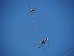Utility lineworkers utilize the Mini LineFly&trade; to install PLP BIRD-FLIGHT&trade; Diverters on overhead power lines.