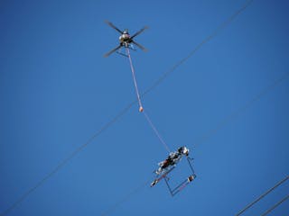Utility lineworkers utilize the Mini LineFly&trade; to install PLP BIRD-FLIGHT&trade; Diverters on overhead power lines.