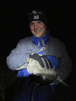 The author with a sage grouse, a ground-dwelling bird vulnerable to habitat disruption.