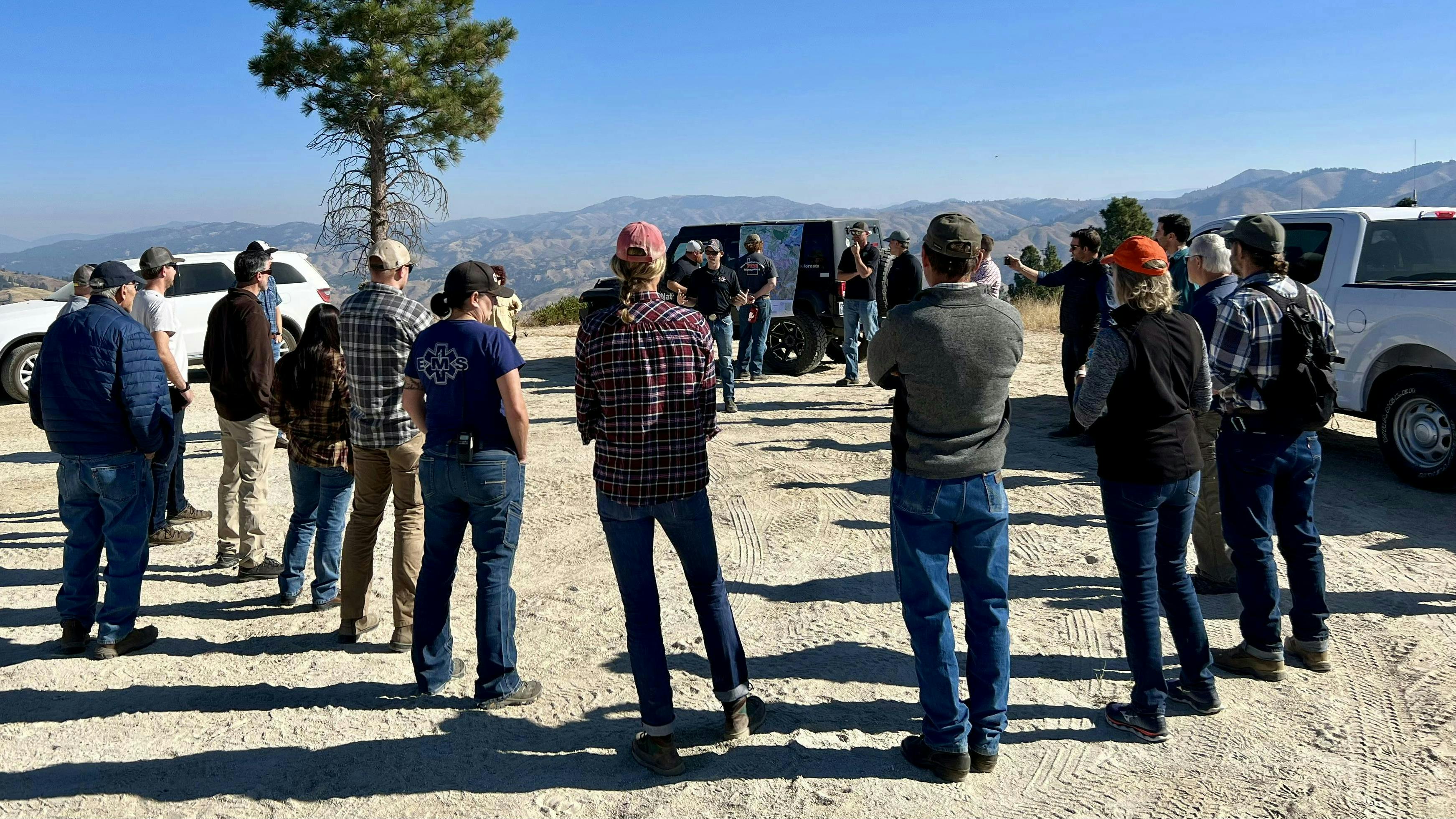 Southern Idaho All Lands Partnership group discuss wildfire risk and evaluate project prioritization during July 2022 field tour in Wilderness Ranch, Idaho.