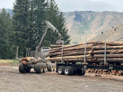 Logs from fuel reduction efforts being loaded on trucks for transport to community firewood bank programs. Photo by D. Southard. Logs from fuel reduction efforts being loaded on trucks for transport to community firewood bank programs. Photo by D. Southard.