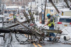 A Con Edison worker with insulated tools approaches a downed distribution pole on a Yonkers street after a storm in March 2018. A Con Edison worker with insulated tools approaches a downed distribution pole on a Yonkers street after a storm in March 2018.
