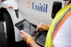 A Unitil field worker using a mobile tablet. Unitil performs regular cyber threat assessments throughout the year.