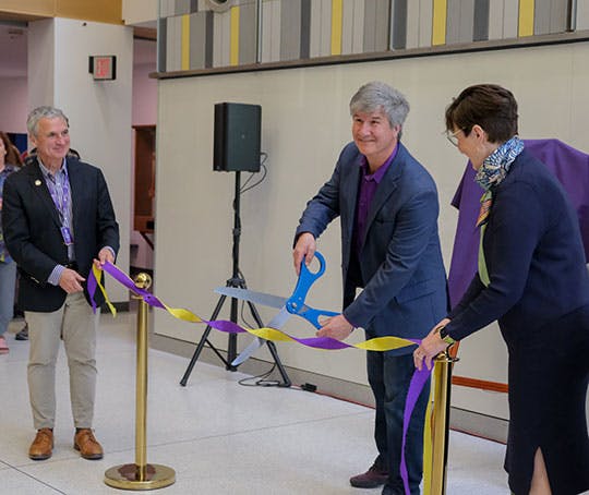 Alfred University President Mark Zupan (left), Joe Franz, senior director of Advance Technology Organization with GE Vernova (center) and Patricia Nilsen &rsquo;88, president and CEO of the Rochester Gas and Electric and New York State Electric & Gas, participate in the ribbon-cutting ceremony unveiling a new electrical grid training lab on McMahon Engineering Building on the Alfred University campus.