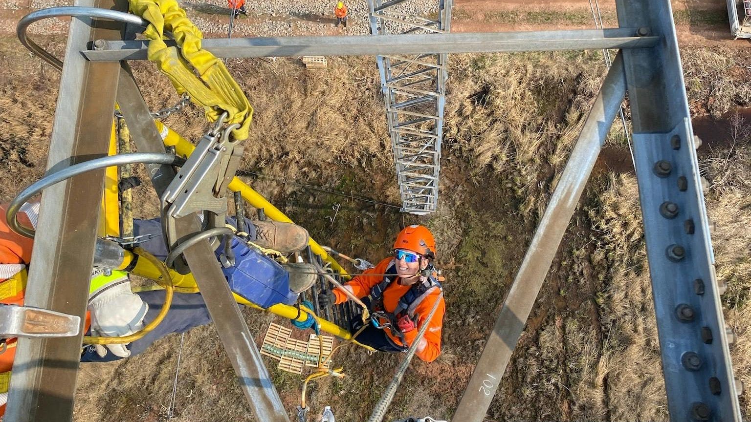 Melissa Dawe, a fourth-year apprentice with Connect Atlantic Utility Services, re-insulates a 345 kV line.