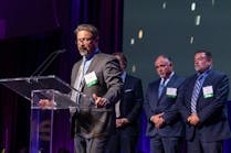Tempest Energy&rsquo;s VP of Customer Relations Adam Guillory (with CEO Bill Cain (l) and COO Mike Zappone (r) in background) thanks Entergy&rsquo;s judges, employees, and guests after accepting the Premier Supplier Storm Response Award.