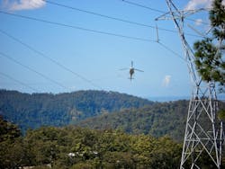 Aerial stringing of a transmission line in Queensland, Australia.