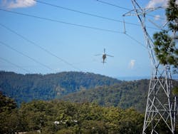 Aerial stringing of a transmission line in Queensland, Australia. Aerial stringing of a transmission line in Queensland, Australia.