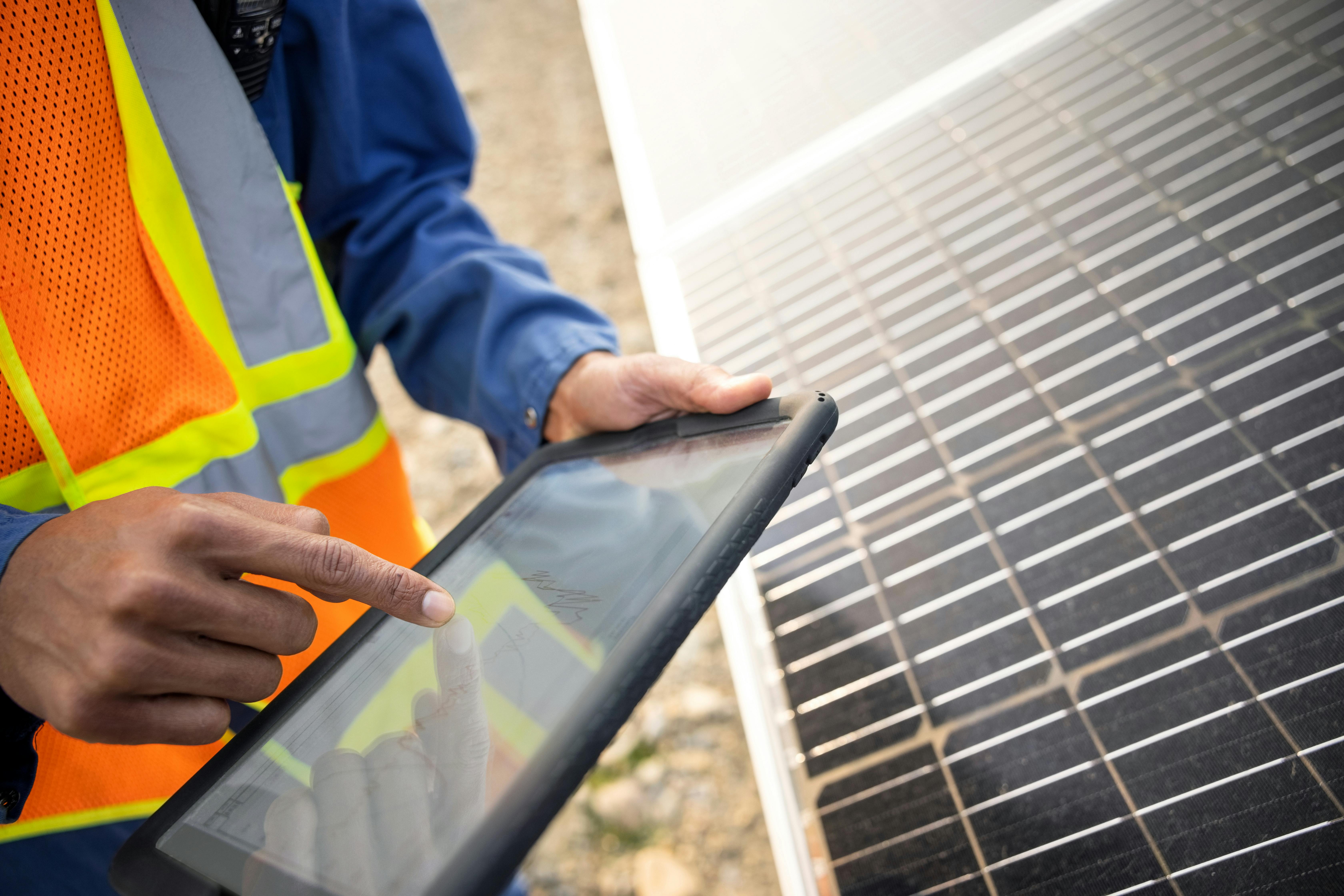 66747112df88c572fb458222 Technicianusingdigitaltabletbysolarpanels Ss 21281