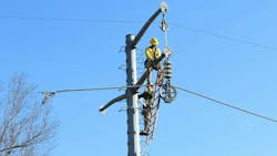 Linemen installing conductor. Linemen installing conductor.