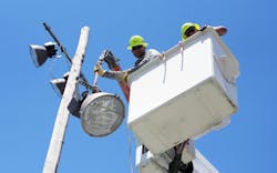 Darren Hess and Mike Blackburn of Ameren Illinois safely remove the olds lights near the tennis courts at Lincoln Park. Once the lights were removed the Ameren Illinois team carefully cut the wooden poles in pieces and safely lowered the pieces to the ground. Darren Hess and Mike Blackburn of Ameren Illinois safely remove the olds lights near the tennis courts at Lincoln Park. Once the lights were removed the Ameren Illinois team carefully cut the wooden poles in pieces and safely lowered the pieces to the ground.