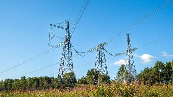 View of fragment of power line as component of large electrical networks and system of power equipment. Electricity transmission, electric current. Energy supply of regions. Selective focus.