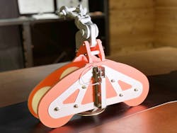 The stringing block features a radius shape and is made of non-conductive materials and aluminum. It mounts to the top of a crossarm or can be hung in a transmission and distribution model. The stringing block features a radius shape and is made of non-conductive materials and aluminum. It mounts to the top of a crossarm or can be hung in a transmission and distribution model.