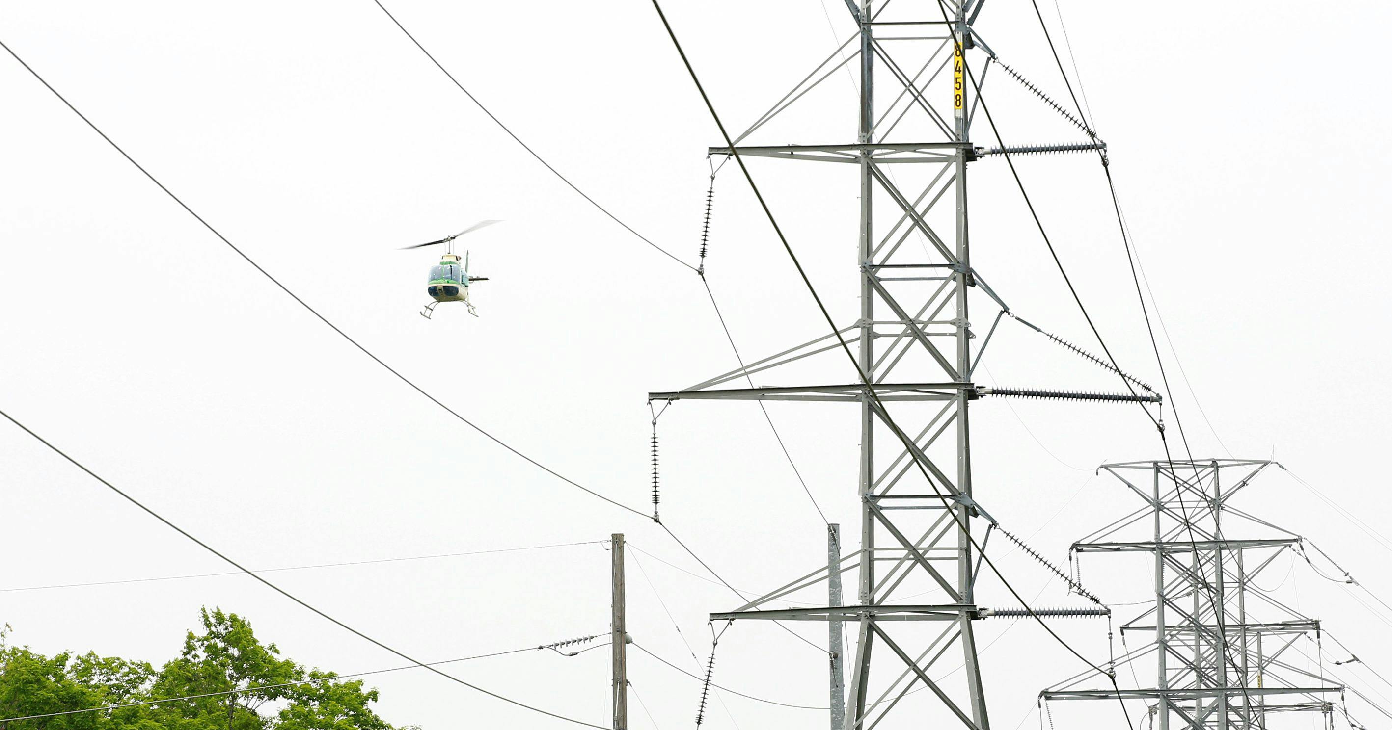 When power outages occur, electric utilities deploy skilled technicians via helicopters and drones to repair high-voltage transmission lines quickly.