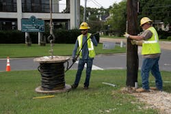 Cleco Power employees, Thailyr Spears (left), power line technician II, and Robert Dewitt, power line technician IV, install new underground service triplex cables to power the new EV meter center. Cleco Power employees, Thailyr Spears (left), power line technician II, and Robert Dewitt, power line technician IV, install new underground service triplex cables to power the new EV meter center.