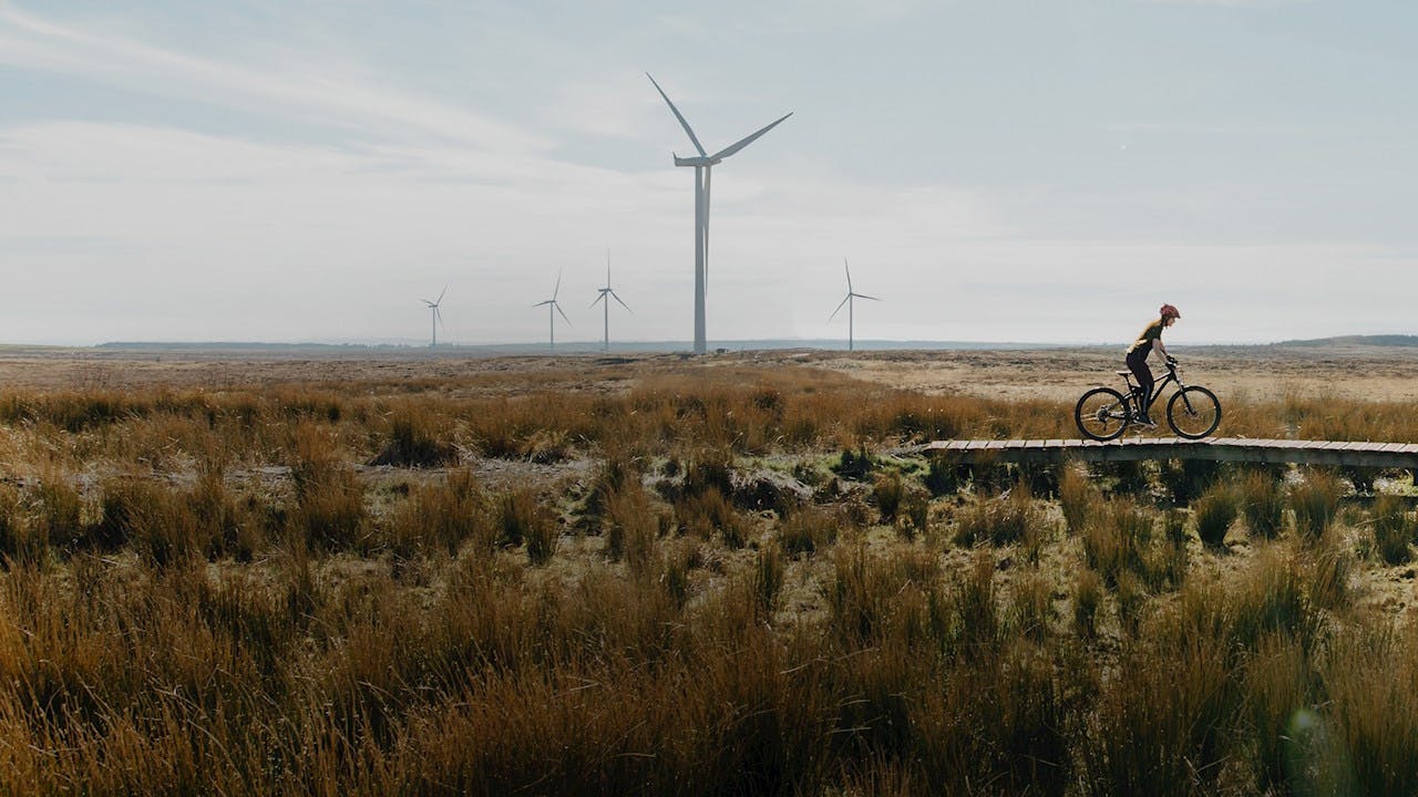6717b4e5b8c6cfac08743e8e A Woman Riding A Mountain Bike Kv