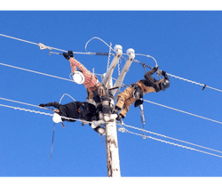 Alaska line workers perform service on a distribution pole. Alaska line workers perform service on a distribution pole.