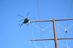 OPGW clipping by helicopter. OPGW clipping by helicopter.