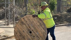 Journeyman Lineman Steve Freeman rolls one of the seven donated wire spools onto the grounds of Peoria County Animal Protection Services. Journeyman Lineman Steve Freeman rolls one of the seven donated wire spools onto the grounds of Peoria County Animal Protection Services.