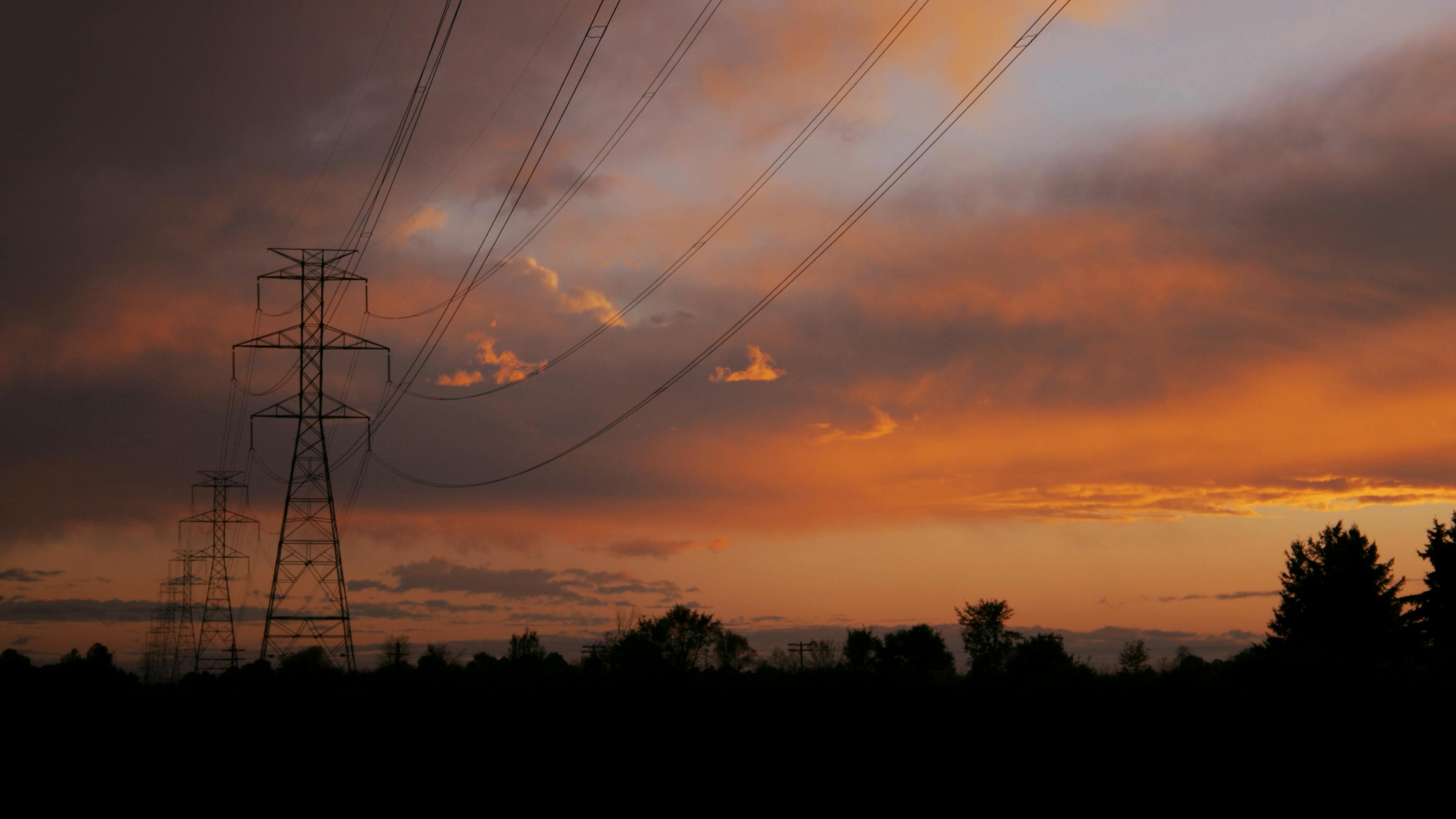transmission towers at sunset