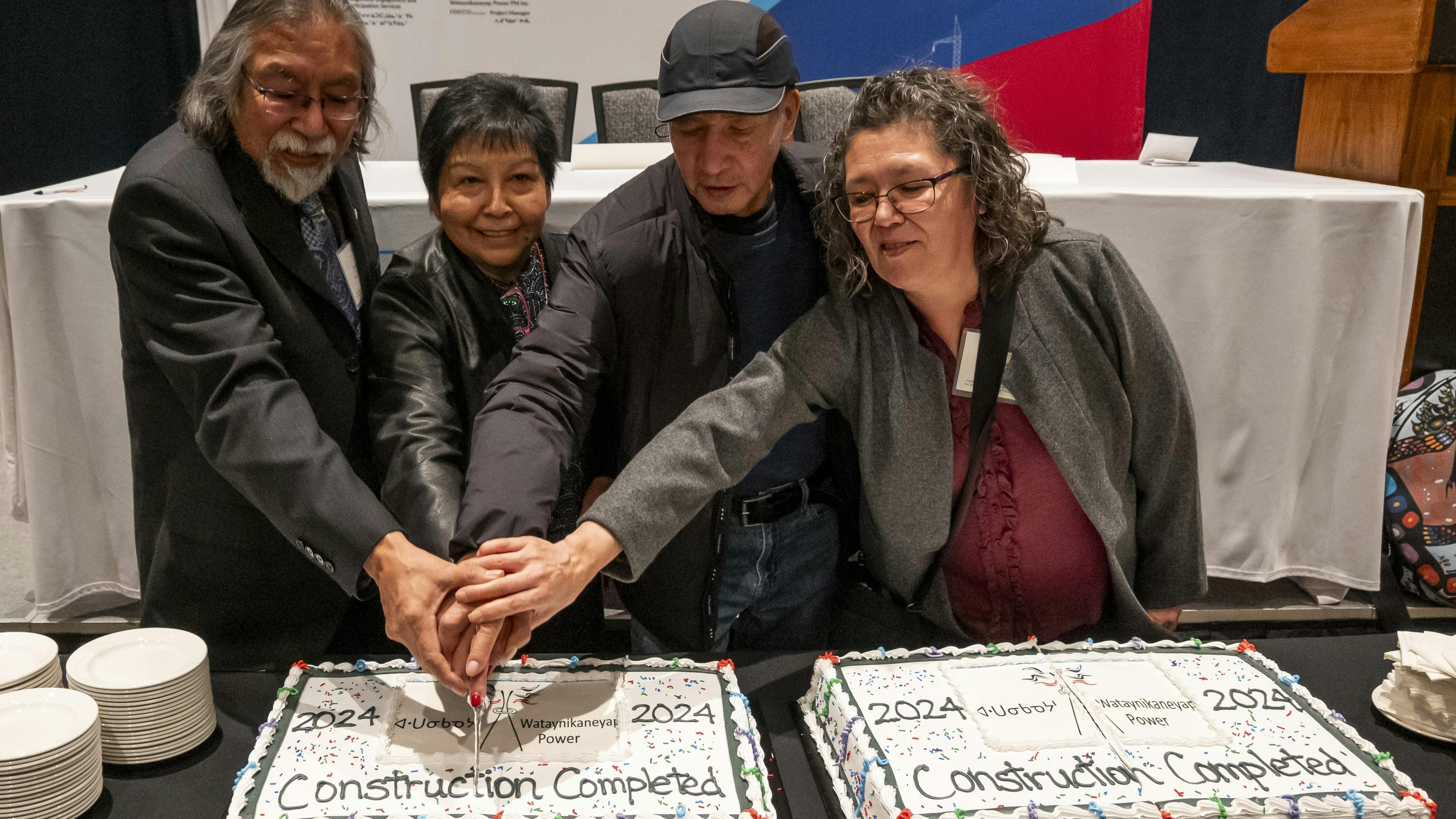 Frank McKay, Margaret Kenequanash, Harry Meekis, and Lucie Edwards cut a celebratory cake to signify the completion of Wataynikaneyap Power&rsquo;s construction, connecting remote First Nations communities to reliable power.