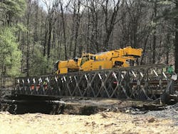 A large crane on a temporary bridge. A large crane on a temporary bridge.