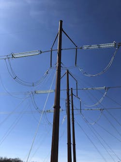 A temporary three-pole guyed structure. A temporary three-pole guyed structure.