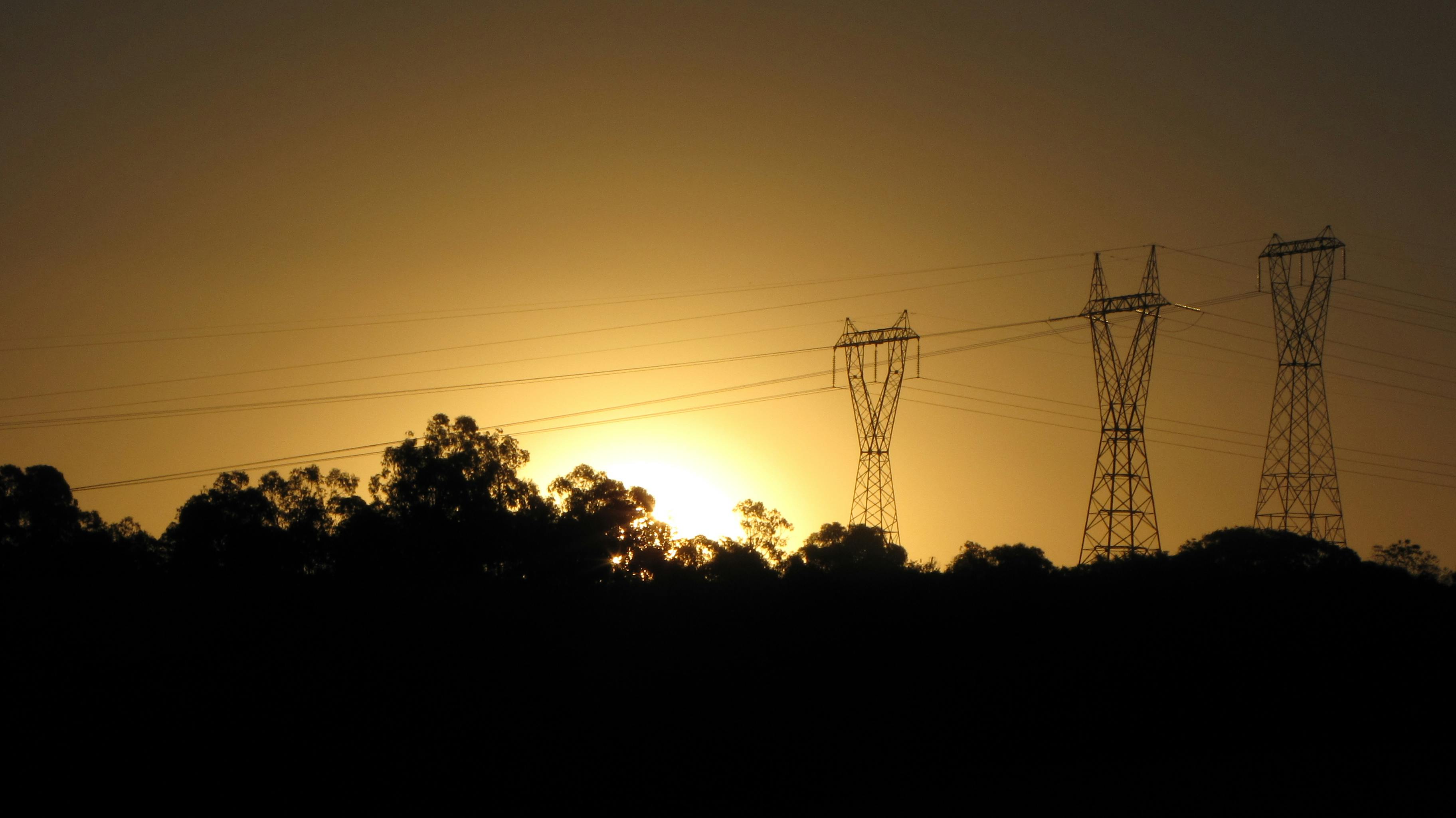 Sunset over a transmission line.