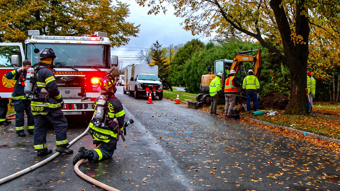 The fire department stands by during a call for gas main damage.
