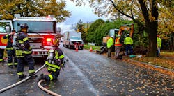The fire department stands by during a call for gas main damage. The fire department stands by during a call for gas main damage.