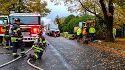 The fire department stands by during a call for gas main damage. The fire department stands by during a call for gas main damage.