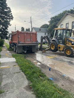 Workers perform water main repairs. Workers perform water main repairs.