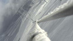 An ice-caked power line that has become twisted. An ice-caked power line that has become twisted.