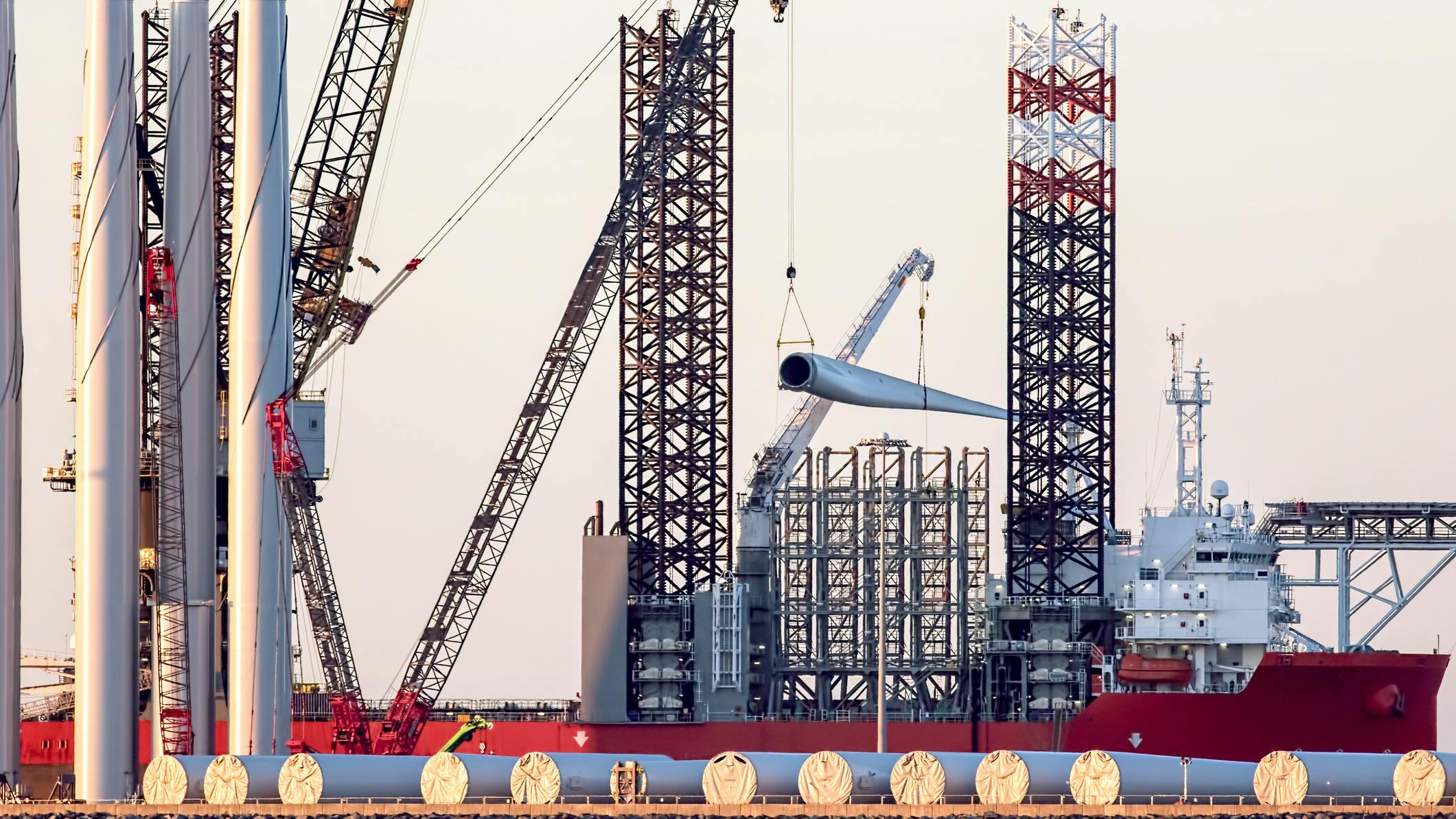 Offshore wind turbine parts being loaded onto supply vessel in the UK.