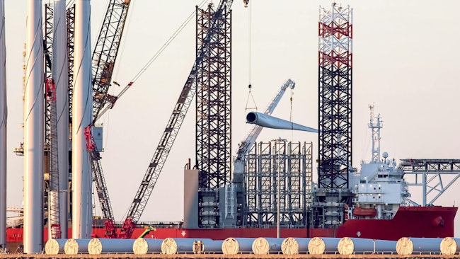 Offshore wind turbine parts being loaded onto supply vessel in the UK.