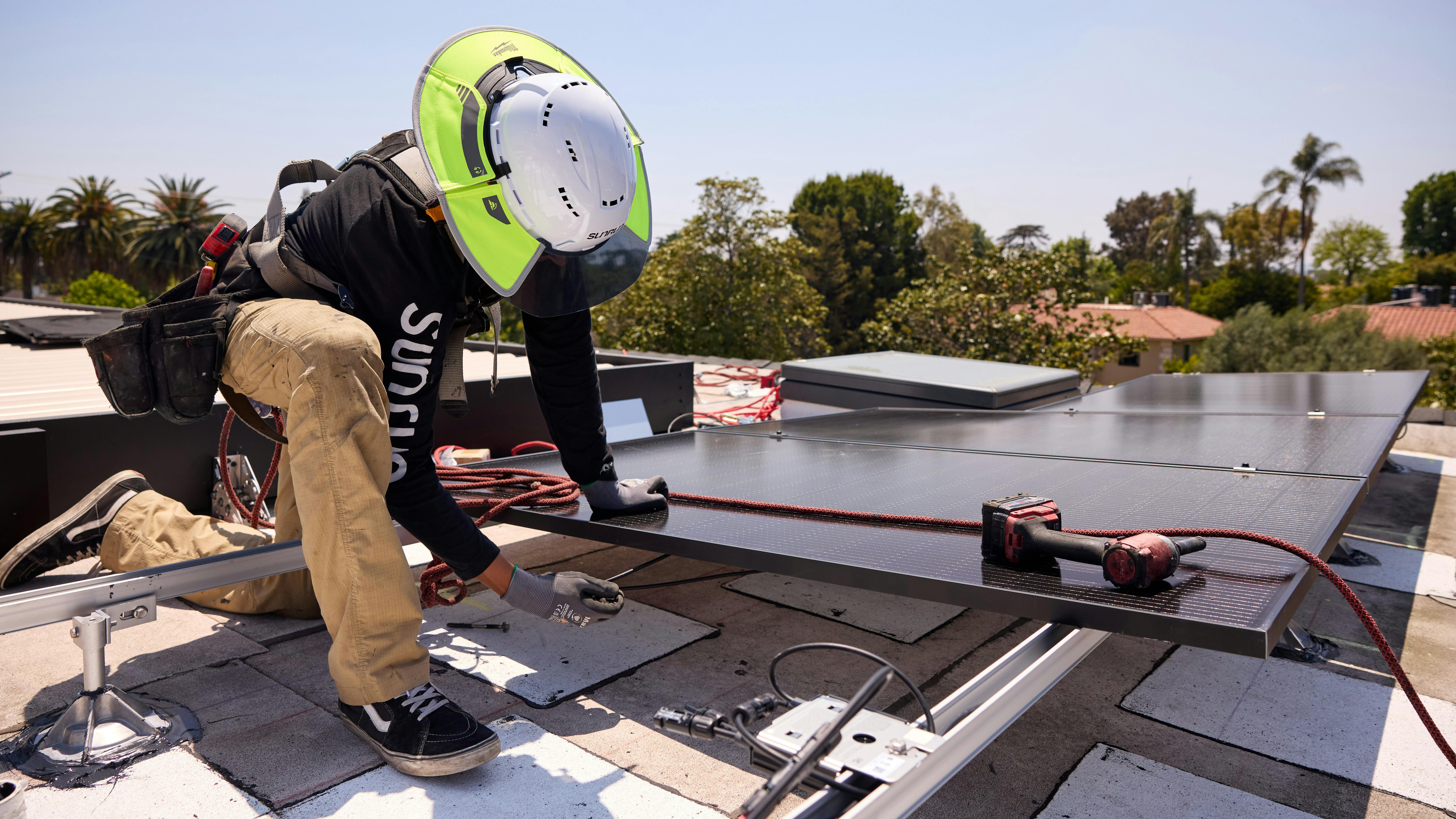 Installing rooftop solar panel.