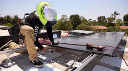 Installing rooftop solar panel.