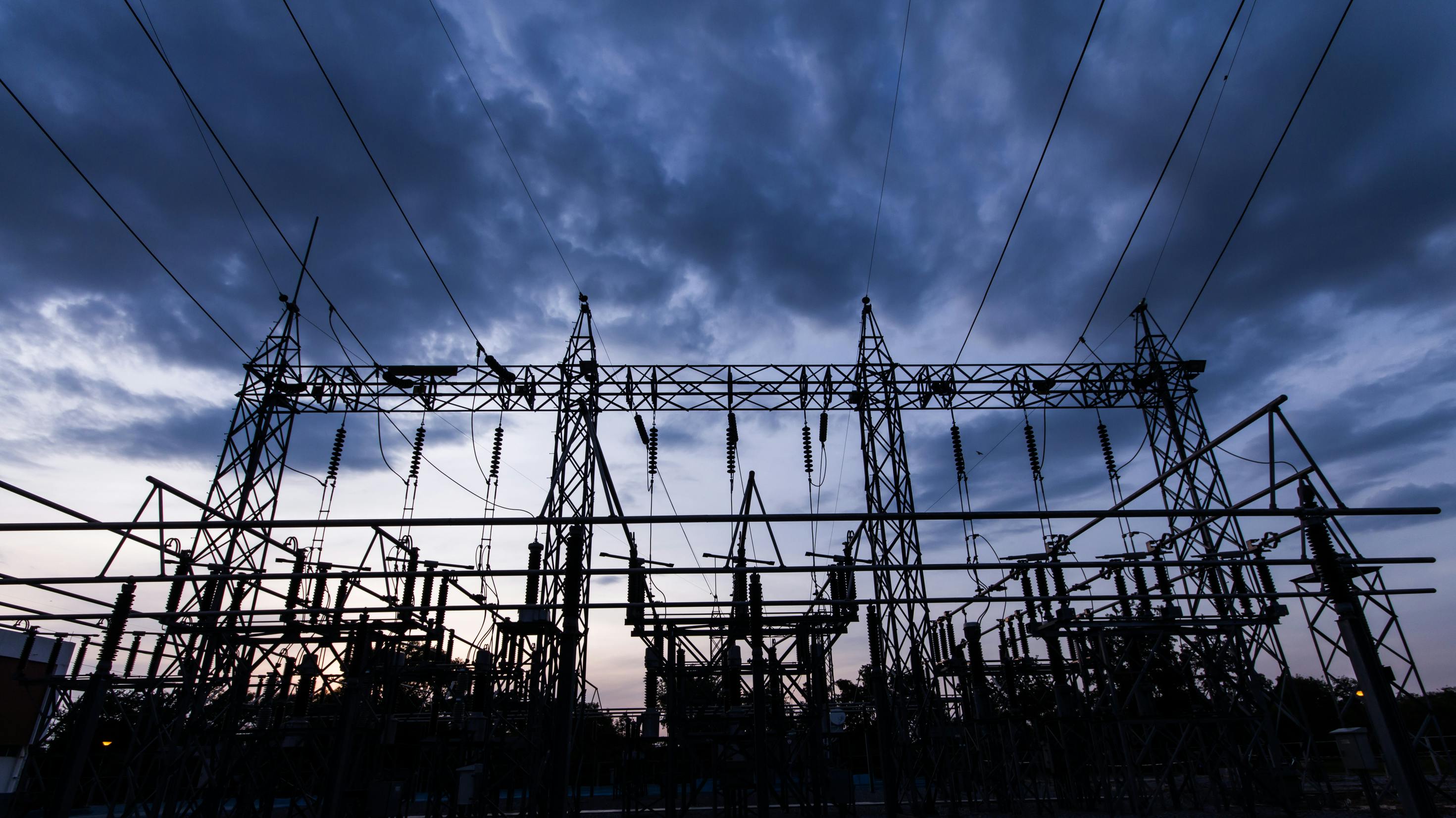 Silhouette of a substation at night.