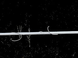 This segmented image of a transmission line section, highlighting damage twills in the power line and a hole between them. This segmented image of a transmission line section, highlighting damage twills in the power line and a hole between them.