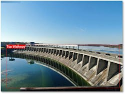 This lateral drone shot of Long Sault Dam shows all bays, the top walkway and the gentry crane used for manipulating flow/crest gates. This lateral drone shot of Long Sault Dam shows all bays, the top walkway and the gentry crane used for manipulating flow/crest gates.
