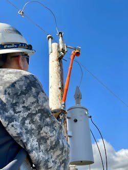A Radar Engineers hot stick line sniffer tool is used to test for RFI in a porcelain cutout bracket. A Radar Engineers hot stick line sniffer tool is used to test for RFI in a porcelain cutout bracket.