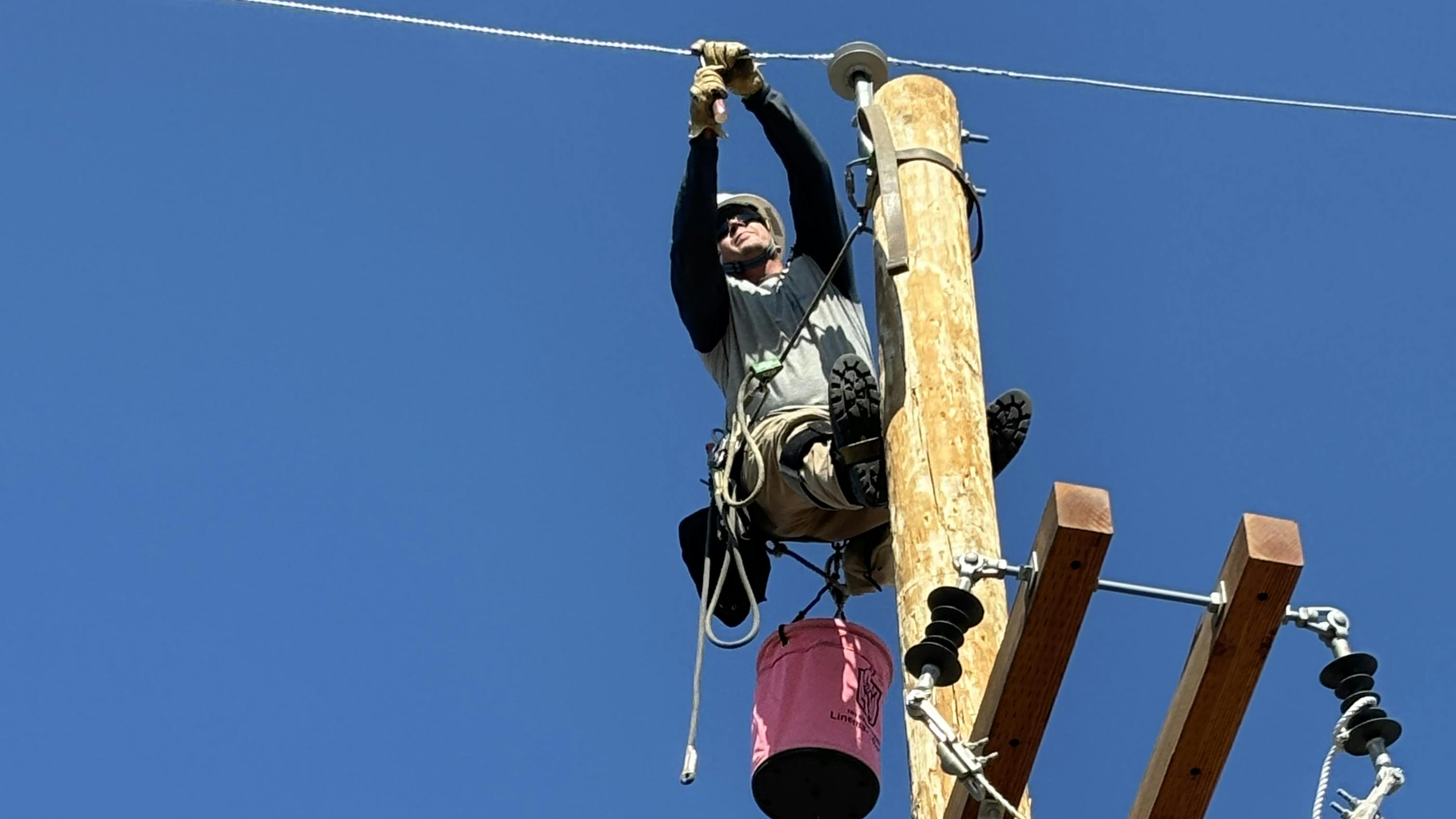 Logan Pollei, an apprentice for Duke Energy, removes the preform from the line to complete this step in the second mystery event at the 2024 International Lineman&rsquo;s Rodeo.