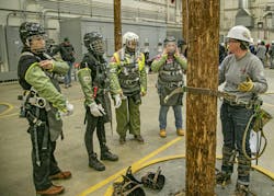 Ashley Siwula, ComEd overhead lineworker, provides a safety refresher to Women’s Climb Clinic participants before they begin practicing climbing the utility pole Ashley Siwula, ComEd overhead lineworker, provides a safety refresher to Women’s Climb Clinic participants before they begin practicing climbing the utility pole