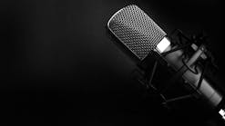 Microphone against black backdrop Microphone against black backdrop